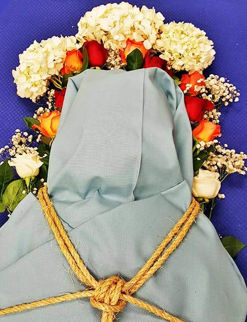 Body shroud with flowers around the head